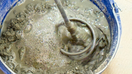 Whirling cauldron of cement sorcery, evoking ancient masonry rituals and niche holiday of Builders Day, industrial art unfolds