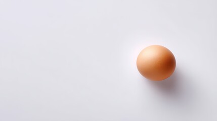Single Brown Egg on Plain White Surface with Soft Shadow, Ideal for Culinary, Dietary, or Natural Food Concepts