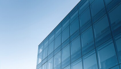 Contemporary corporate structure featuring a transparent glass exterior against a bright sky.