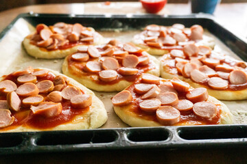 Homemade mini pizzas with sausages. Pastries. Bread. Dough.
