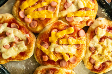 Homemade mini pizzas with sausages. Pastries. Bread. Dough.