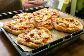 Homemade mini pizzas with sausages. Pastries. Bread. Dough.