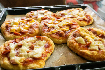 Homemade mini pizzas with sausages. Pastries. Bread. Dough.