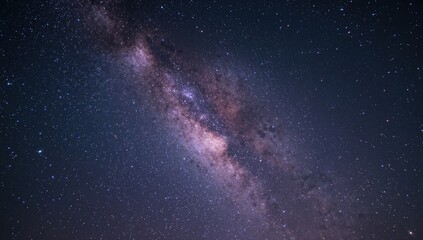 Wide-angle shot of the Milky Way stretching across the night sky, captured with long exposure and visible grain effect