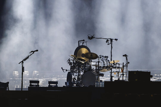 Professional drum kit on dark stage with smoke and lights