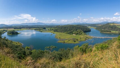 Fototapeta premium Scenic panorama of a large dam surrounded by lush greenery
