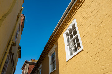 Abstract view of a famous, narrow street in the United Kingdom. Newly painted, pastel colours and traditional sash windows can be seen.
