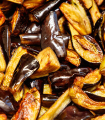 A pile of cooked vegetables including eggplant and peppers