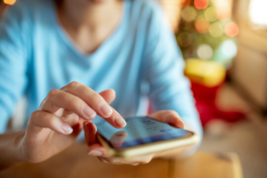 Young adult woman using smartphone at home