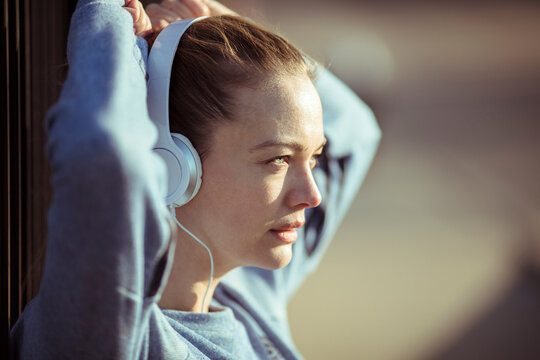 Young woman listening to music outdoors