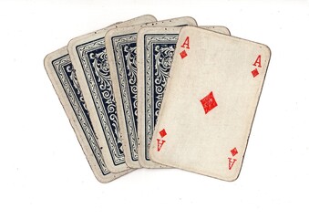 A hand of grubby old vintage playing cards with one card revealed on a white background.