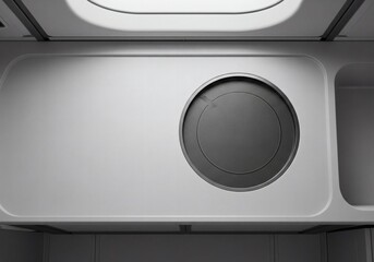 abstract close-up of a futuristic gray surface with circular detail and grille