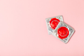 Condoms on a colored background. Colorful fruit-themed condoms in packaging. Safe sex concept. Contraceptive. Different birth control methods. Aids prevention. World AIDS Day. Sexual health.
