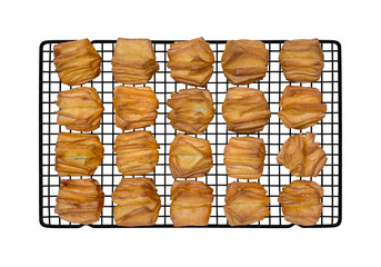 Top view a lot of Puff pastry on cooling rack fresh out of the oven isolated on white background