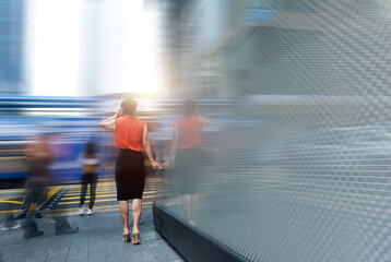 Woman using phone and standing on the street