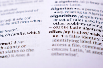Close Up Of English Dictionary Page With Word - Alias