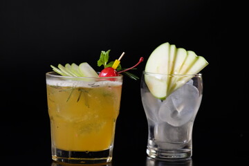 Elegant cocktail drinks served on a black table with fruits for party