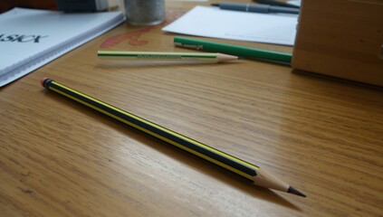 Black and yellow striped pencil with sharp tip for office and school use