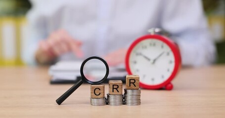 Exploring the importance of time management and budget planning with coins and a clock in focus - Powered by Adobe