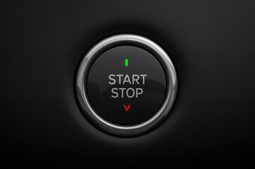 Engine ignition button for a high-end car, displayed against a dark backdrop.