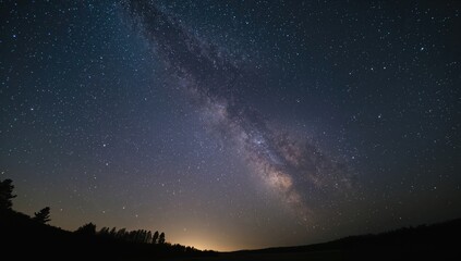 Fototapeta premium Wide-angle lens shot of the night sky featuring the Milky Way