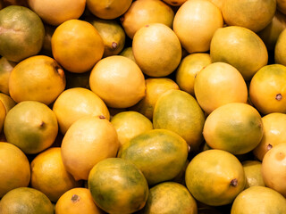 Pile of fresh ripe lemons as a natural background