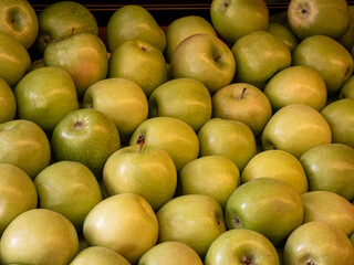 Fresh and ripe green apples background texture