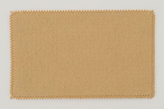 A rectangular piece of burlap fabric with a zigzag stitched edge isolated on white