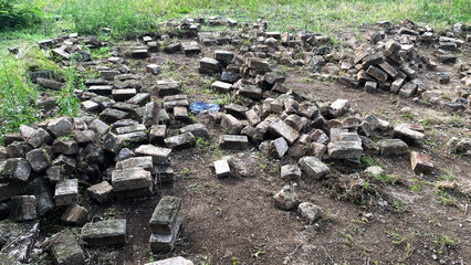 Disorganized Brick Pile on Dirt Ground in Outdoor Setting