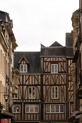Obraz premium Colorful historic buildings and detailed stone architecture in Rouen, France. Charming medieval street scene showcasing European culture, history, and heritage.