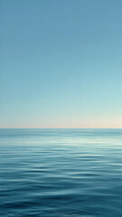 Obraz premium A tranquil ocean view in soft early morning light. The pale blue tones of water and sky create a minimal and serene composition.