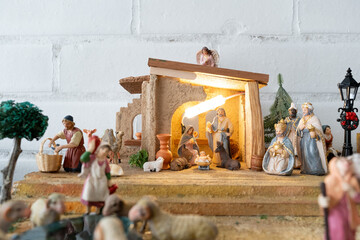 Traditional Christmas Nativity scene with figurines of the birth of Jesus, including Mary, Joseph,...