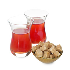 Traditional Turkish tea in glass cups and sugar isolated on white