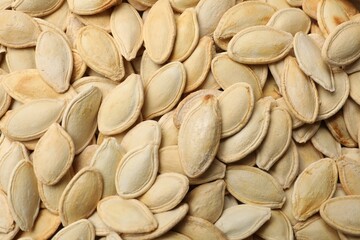 Unpeeled pumpkin seeds as background, closeup view