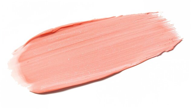 Swatch of peachy pink color correcting concealer with thick creamy texture on white background