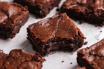 Homemade chocolate brownie pile on a plain white surface, dessert and bakery theme