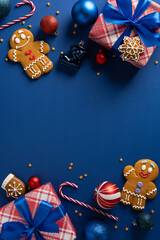 A vertical bright holiday scene featuring wrapped gifts, gingerbread cookies, candy canes,...