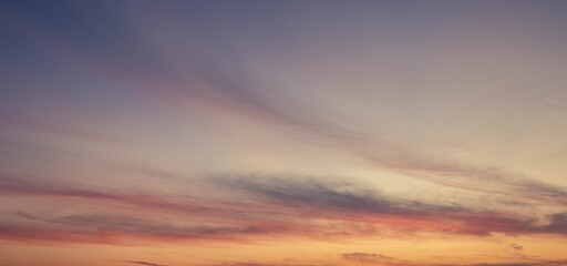 Dramatic sunset sky with orange colored clouds.
