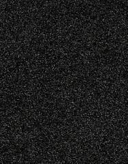 Fototapeta premium A close-up view capturing the texture of a dark, speckled surface