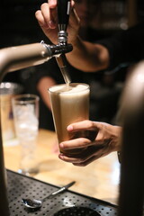 Pouring a frothy drink into a glass