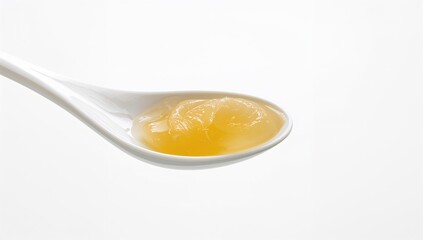 Single spoonful of clarified butter on a white background