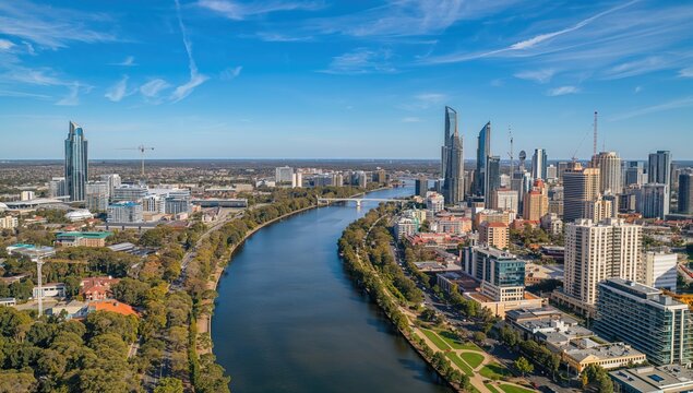 Aerial view of the narrow river running through a metropolitan area, surrounded by high-rise buildings.