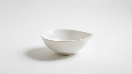 Ceramic bowl in white displayed against a plain white backdrop