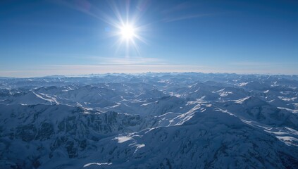 Fototapeta premium Aerial perspective of snow-blanketed mountains with sunlight illuminating the landscape. Blurred abstract backdrop. Image features provided by a space agency.