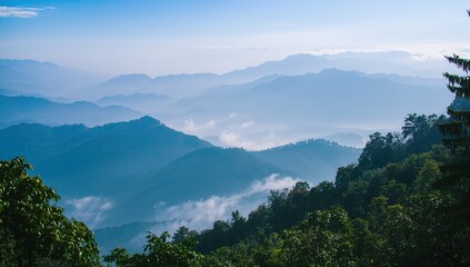 Scenic Himalayan peaks viewed from the trekking path at Khalia Top, with mountain silhouettes emerging through colorful mist.