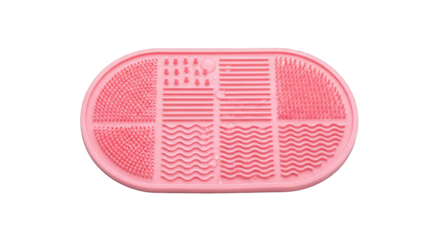 Pink silicone makeup brush cleaning mat on transparent background