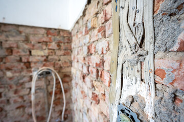 Open interior space with exposed red brick, combining raw materials and industrial charm