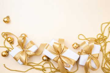 Luxury Christmas and New Year background with gifts, golden ribbons and ornaments. Elegant minimal composition with copy space.
