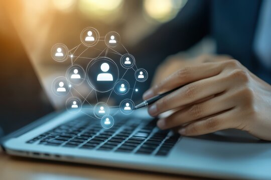Digital Networking: Hands working on laptop with a network of human icons, illustrating the essence of global business collaboration.