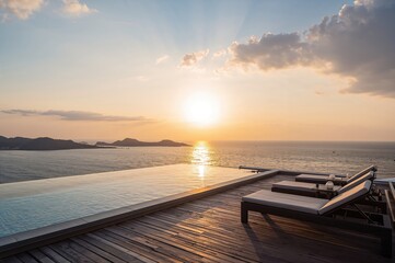 Fototapeta premium Contemporary rooftop pool with infinity edge and relaxing chair overlooking the ocean at sunset